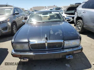 1990 Jaguar XJ with VIN SAJKY1745LC622713, listed as a Copart auction lot 56545414 with Not Provided miles and Salvage Title. Bid and sale history available at DreamBid. Image 5.