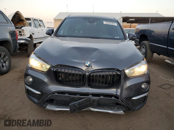 2018 BMW X1 xDrive28i with VIN WBXHT3C38J3H33310, listed as a Copart auction lot 73492324 with 88,620 mi miles and Salvage Title. Bid and sale history available at carsss.com. Image 5.
