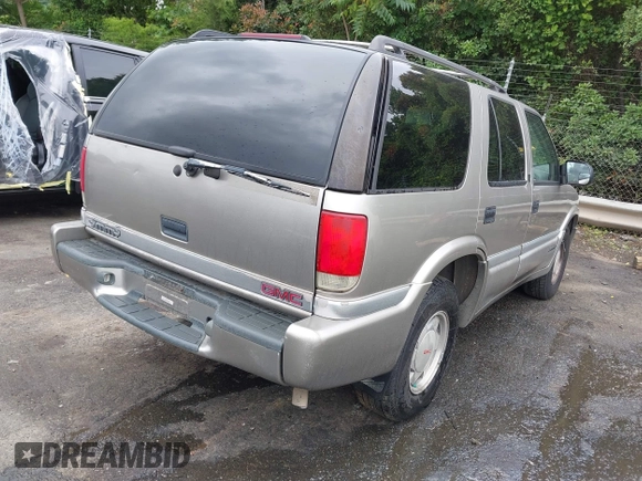 1999 GMC Jimmy SLE z VIN 1GKCS13W0X2512048, wystawiony jako IAAI lot #42364175 z przebiegiem 195 301 mil mil oraz . Historia ofert i sprzedaży dostępna na DreamBid. Obrazek 4.