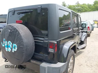 2015 Jeep Wrangler Unlimited Sahara with VIN 1C4HJWEG3FL661568, listed as a IAAI auction lot 42387810 with 140,927 mi miles and . Bid and sale history available at DreamBid. Image 4.