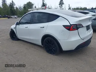 2021 Tesla Model Y Standard Range with VIN 5YJYGDED9MF121828, listed as a IAAI auction lot 42119518 with 34,454 mi miles and . Bid and sale history available at carsss.com. Image 3.