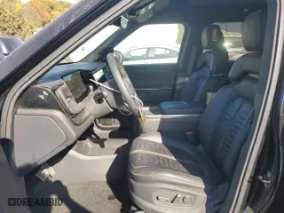 2022 Rivian R1S Launch Edition with VIN 7PDSGABL6NN001531, listed as a Copart auction lot 77143684 with 27,241 mi miles and Salvage Title. Bid and sale history available at carsss.com. Image 7.