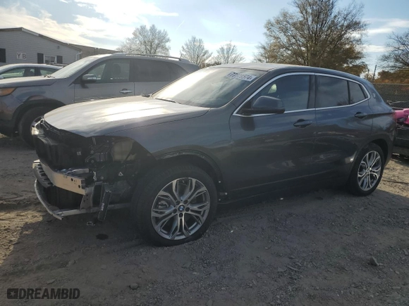 2021 BMW X2 xDrive28i with VIN WBXYJ1C07M5S21169, listed as a Copart auction lot 77829574 with 24,173 mi miles and Salvage Title. Bid and sale history available at carsss.com. Image 1.