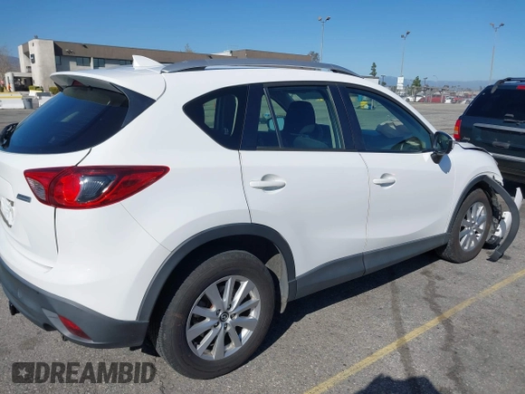 2016 Mazda CX-5 Sport with VIN JM3KE2BY9G0879654, listed as a IAAI auction lot 41819154 with 65,586 mi miles. Bid and sale history available at carsss.com. Image 4.