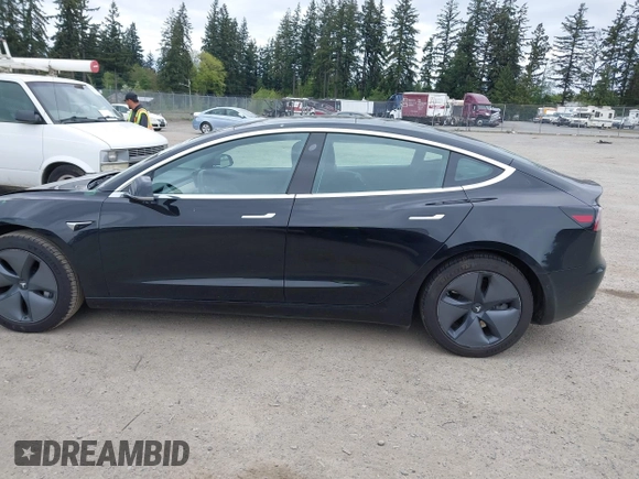 2019 Tesla Model 3 Mid Range with VIN 5YJ3E1EA6KF415656, listed as a IAAI auction lot 42140763 with 71,408 mi miles and . Bid and sale history available at carsss.com. Image 15.
