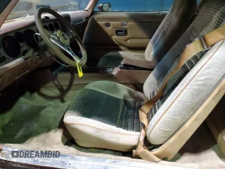 1979 Pontiac Firebird z VIN 2W87K9N184050, wystawiony jako Copart lot #75937874 z przebiegiem 18 509 mil mil oraz Szkody całkowita. Historia ofert i sprzedaży dostępna na DreamBid. Obrazek 7.