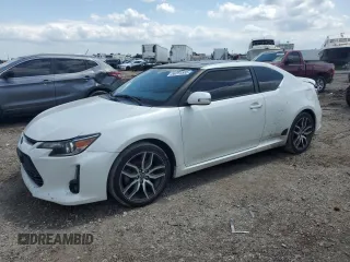 2015 Scion tC z VIN JTKJF5C74FJ000488, wystawiony jako Copart lot #56291555 z przebiegiem 186 817 mil mil oraz Czysty tytuł • Clean title. Historia ofert i sprzedaży dostępna na DreamBid. Obrazek 1.