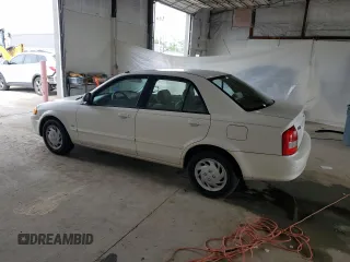 1999 Mazda Protege DX z VIN JM1BJ2224X0173126, wystawiony jako Copart lot #57389245 z przebiegiem 155 534 mil mil oraz Szkoda całkowita • Salvage title. Historia ofert i sprzedaży dostępna na DreamBid. Obrazek 2.