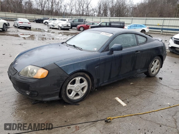 2003 Hyundai Tiburon GT z VIN KMHHN65F13U068658, wystawiony jako Copart lot #81799404 z przebiegiem 163 148 mil mil oraz Szkoda całkowita • Salvage title. Historia ofert i sprzedaży dostępna na DreamBid. Obrazek 1.