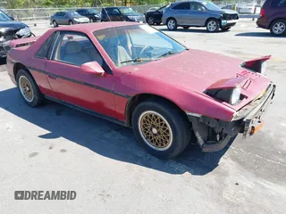 1985 Pontiac Fiero z VIN 1G2PE37R3FP242761, wystawiony jako IAAI lot #42006726 z przebiegiem 221 395 mil mil oraz . Historia ofert i sprzedaży dostępna na DreamBid. Obrazek 1.