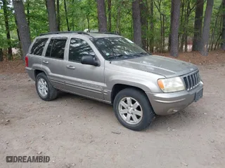 1999 Jeep Grand Cherokee Limited with VIN 1J4GW68N5XC684157, listed as a IAAI auction lot 42104283 with 164,506 mi miles. Bid and sale history available at carsss.com. Image 1.