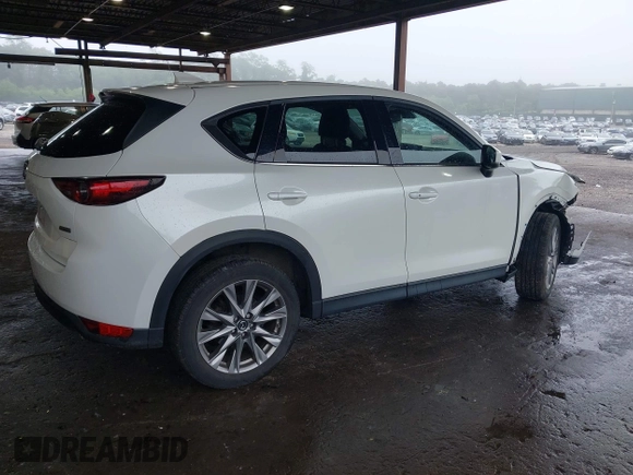 2019 Mazda CX-5 Grand Touring with VIN JM3KFBDMXK0648813, listed as a IAAI auction lot 42524680 with 23,521 mi miles and . Bid and sale history available at DreamBid. Image 4.