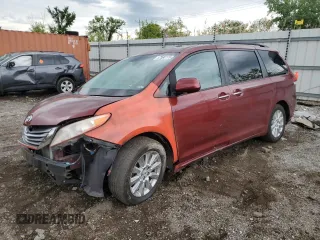 2011 Toyota Sienna XLE AAS with VIN 5TDYK3DCXBS052710, listed as a Copart auction lot 57985115 with 228,600 mi miles and Salvage title. Bid and sale history available at DreamBid. Image 1.