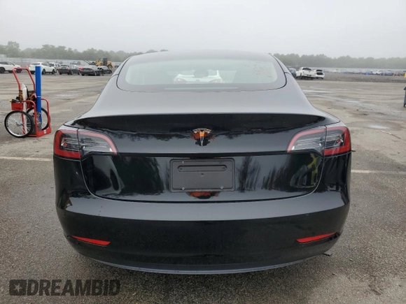 2023 Tesla Model 3 with VIN 5YJ3E1EA9PF687187, listed as a Copart auction lot 61044055 with 7,007 mi miles and Salvage title. Bid and sale history available at DreamBid. Image 6.