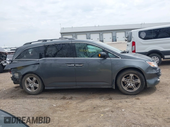 2012 Honda Odyssey Touring with VIN 5FNRL5H99CB028304, listed as a IAAI auction lot 42031916 with 216,185 mi miles and . Bid and sale history available at DreamBid. Image 14.