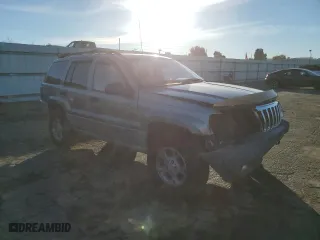1999 Jeep Grand Cherokee Laredo with VIN 1J4GW58NXXC747537, listed as a Copart auction lot 87310234 with 0 mi miles and Salvage Title. Bid and sale history available at carsss.com. Image 4.