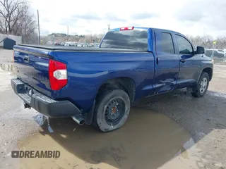 2014 Toyota Tundra SR with VIN 5TFUM5F17EX056082, listed as a IAAI auction lot 41884095 with 155,036 mi miles and . Bid and sale history available at DreamBid. Image 4.