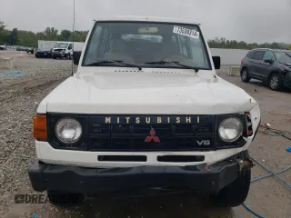 1990 Mitsubishi Montero z VIN JA4GJ31S2LJ003083, wystawiony jako Copart lot #73539314 z przebiegiem 115 191 mil mil oraz Nie do naprawy • Non repairable. Historia ofert i sprzedaży dostępna na DreamBid. Obrazek 5.