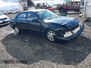 2000 Mazda 626 LX with VIN 1YVGF22CXY5123930, listed as a IAAI auction lot 40712369 with 210,234 mi miles. Bid and sale history available at carsss.com. Image 1.