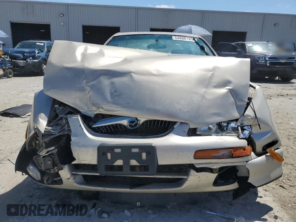 2000 Mazda Millenia with VIN JM1TA2210Y1614967, listed as a Copart auction lot 53606185 with 120,288 mi miles and Salvage Title. Bid and sale history available at DreamBid. Image 5.