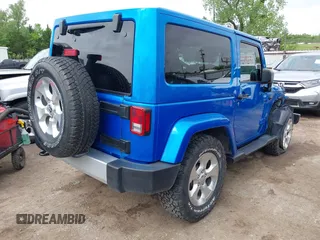 2015 Jeep Wrangler Sahara with VIN 1C4AJWBG9FL663959, listed as a IAAI auction lot 42133900 with 56,253 mi miles and . Bid and sale history available at DreamBid. Image 4.