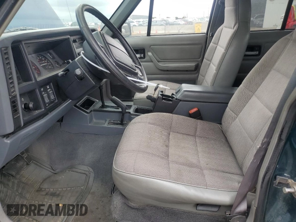 1996 Jeep Cherokee Sport with VIN 1J4FJ68S3TL251074, listed as a Copart auction lot 59593955 with 181,482 mi miles and Salvage title. Bid and sale history available at DreamBid. Image 7.