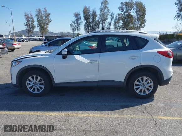 2016 Mazda CX-5 Sport with VIN JM3KE2BY9G0879654, listed as a IAAI auction lot 41819154 with 65,586 mi miles. Bid and sale history available at carsss.com. Image 14.