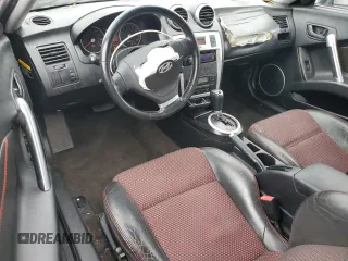 2006 Hyundai Tiburon GT z VIN KMHHN65F66U215304, wystawiony jako Copart lot #56141635 z przebiegiem 149 118 mil mil oraz Szkoda całkowita • Salvage title. Historia ofert i sprzedaży dostępna na DreamBid. Obrazek 8.
