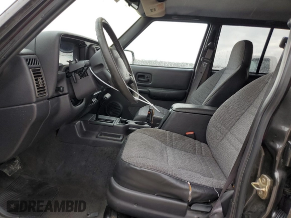 1999 Jeep Cherokee Sport with VIN 1J4FT68S2XL656679, listed as a Copart auction lot 88145875 with 254,038 mi miles and Salvage title. Bid and sale history available at DreamBid. Image 7.