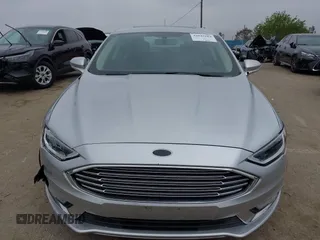 2017 Ford Fusion Hybrid Titanium z VIN 3FA6P0RU7HR300311, wystawiony jako IAAI lot #42045664 z przebiegiem 136 231 mil mil oraz . Historia ofert i sprzedaży dostępna na DreamBid. Obrazek 12.