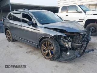 2023 Volkswagen Tiguan SE R-Line Black with VIN 3VVCB7AX2PM107104, listed as a IAAI auction lot 42313212 with 27,500 mi miles and . Bid and sale history available at DreamBid. Image 1.