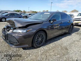 2019 Toyota Avalon Limited Hybrid z VIN 4T1B21FBXKU003688, wystawiony jako Copart lot #69697502 z przebiegiem 48 950 mil mil oraz . Historia ofert i sprzedaży dostępna na DreamBid. Obrazek 1.
