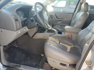 2004 Jeep Grand Cherokee Laredo with VIN 1J4GX48N74C406647, listed as a Copart auction lot 77631654 with 174,824 mi miles and Salvage Title. Bid and sale history available at carsss.com. Image 7.