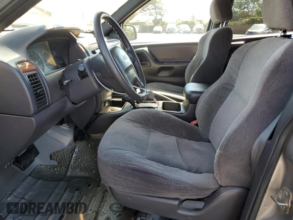 1999 Jeep Grand Cherokee Laredo with VIN 1J4GW58N4XC739465, listed as a Copart auction lot 76130544 with 195,649 mi miles and Salvage title. Bid and sale history available at DreamBid. Image 7.