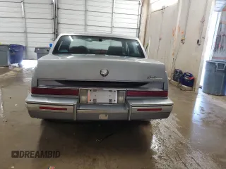 1991 Cadillac Seville z VIN 1G6KS53B2MU809384, wystawiony jako Copart lot #77185134 z przebiegiem 134 769 mil mil oraz Szkody całkowita. Historia ofert i sprzedaży dostępna na DreamBid. Obrazek 6.