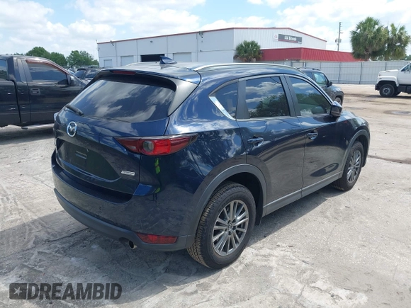 2017 Mazda CX-5 Touring with VIN JM3KFACL0H0227615, listed as a IAAI auction lot 42063618 with 72,291 mi miles. Bid and sale history available at carsss.com. Image 4.