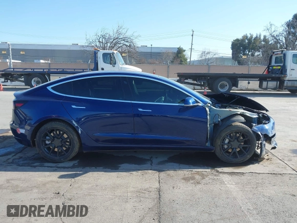 2018 Tesla Model 3 Long Range Battery with VIN 5YJ3E1EA4JF011799, listed as a IAAI auction lot 41765860 with 133,098 mi miles. Bid and sale history available at carsss.com. Image 13.