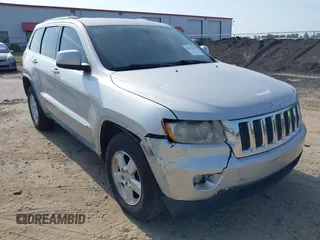 2012 Jeep Grand Cherokee Laredo with VIN 1C4RJEAG7CC187320, listed as a IAAI auction lot 42173736 with 142,704 mi miles. Bid and sale history available at carsss.com. Image 1.