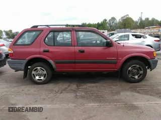 1998 Isuzu Rodeo S z VIN 4S2CK58WXW4325645, wystawiony jako IAAI lot #42013228 z przebiegiem 300 698 mil mil oraz . Historia ofert i sprzedaży dostępna na DreamBid. Obrazek 13.