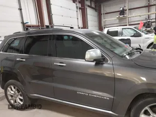 2015 Jeep Grand Cherokee Summit with VIN 1C4RJFJT6FC754799, listed as a IAAI auction lot 41699124 with 124,206 mi miles and . Bid and sale history available at DreamBid. Image 13.