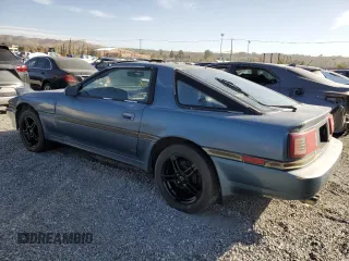 1986 Toyota Supra z VIN JT2MA70L2G0012221, wystawiony jako Copart lot #87328804 z przebiegiem 142 252 mil mil oraz Szkoda całkowita • Salvage title. Historia ofert i sprzedaży dostępna na DreamBid. Obrazek 2.