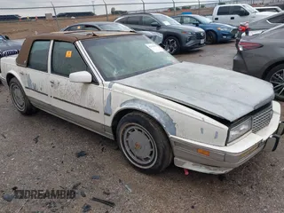1990 Cadillac Seville z VIN 1G6KY533XLU803161, wystawiony jako IAAI lot #42164352 z przebiegiem Nie podano mil oraz . Historia ofert i sprzedaży dostępna na DreamBid. Obrazek 1.