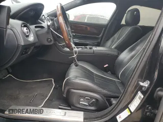 2014 Jaguar XJ Portfolio z VIN SAJWA2GZ2E8V64993, wystawiony jako Copart lot #88774965 z przebiegiem Nie podano mil oraz Szkoda całkowita • Salvage title. Historia ofert i sprzedaży dostępna na DreamBid. Obrazek 7.