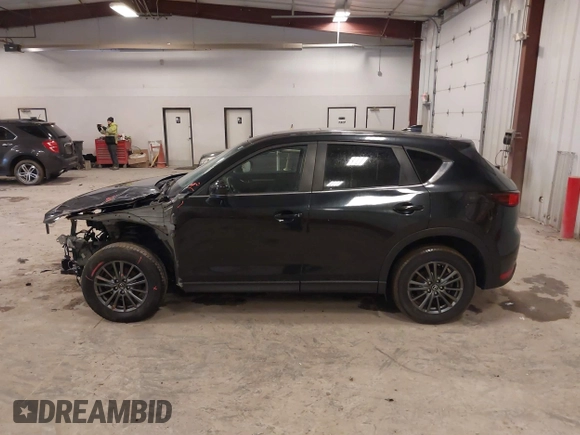 2021 Mazda CX-5 Touring with VIN JM3KFBCM1M1380409, listed as a IAAI auction lot 41677537 with 55,319 mi miles. Bid and sale history available at carsss.com. Image 14.