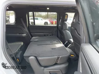 2024 Rivian R1S Adventure with VIN 7PDSGBBA1RN040036, listed as a IAAI auction lot 41694635 with 13,855 mi miles. Bid and sale history available at carsss.com. Image 8.