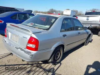 2001 Mazda Protege DX with VIN JM1BJ222810410482, listed as a IAAI auction lot 40799727 with 159,446 mi miles and . Bid and sale history available at DreamBid. Image 4.