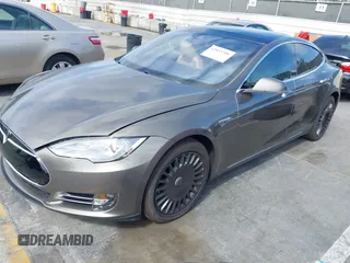 2015 Tesla Model S 85 with VIN 5YJSA1E14FF120455, listed as a IAAI auction lot 42053306 with 62,817 mi miles and . Bid and sale history available at DreamBid. Image 2.