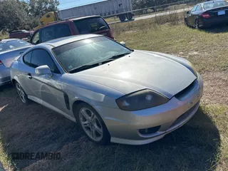 2005 Hyundai Tiburon GT z VIN KMHHN65F85U183258, wystawiony jako Copart lot #83861894 z przebiegiem 281 902 mil mil oraz Tytuł czysty. Historia ofert i sprzedaży dostępna na DreamBid. Obrazek 1.