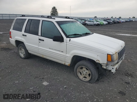 1998 Jeep Grand Cherokee Laredo with VIN 1J4GZ48S1WC165851, listed as a Copart auction lot 84110044 with 306,484 mi miles and Salvage Title. Bid and sale history available at carsss.com. Image 4.
