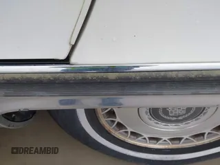 1996 Cadillac Fleetwood z VIN 1G6DW52P1TR700801, wystawiony jako IAAI lot #41945490 z przebiegiem 133 198 mil mil oraz . Historia ofert i sprzedaży dostępna na DreamBid. Obrazek 6.